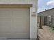 Close-up of the garage with house number, exterior lighting, and gated side yard at 18361 E Eloisa Dr, Gold Canyon, AZ 85118
