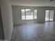 Spacious living room with large windows offering backyard views and access to the patio at 18361 E Eloisa Dr, Gold Canyon, AZ 85118