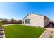 Beautiful backyard features a well-maintained lawn and a charming home exterior, ideal for outdoor enjoyment at 19595 W San Miguel Ave, Litchfield Park, AZ 85340