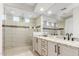 Modern bathroom featuring double sinks, granite countertops, and glass shower with multiple shower heads at 19595 W San Miguel Ave, Litchfield Park, AZ 85340