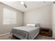 Cozy bedroom with plush carpeting, ceiling fan, and natural light streaming through the window at 19595 W San Miguel Ave, Litchfield Park, AZ 85340