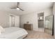Bedroom with neutral tones, carpet, a ceiling fan, and an ensuite bathroom at 19595 W San Miguel Ave, Litchfield Park, AZ 85340