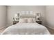 Inviting bedroom with a tufted headboard, neutral colors, and mirrored nightstands at 19595 W San Miguel Ave, Litchfield Park, AZ 85340
