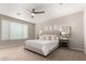 Relaxing bedroom featuring a neutral palette, plush carpeting, and an upholstered headboard at 19595 W San Miguel Ave, Litchfield Park, AZ 85340