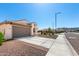 Single-story home with a large driveway and neutral color scheme in a residential neighborhood at 19595 W San Miguel Ave, Litchfield Park, AZ 85340
