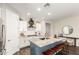 Well-lit kitchen with stainless steel appliances, granite counters, and a blue island at 19595 W San Miguel Ave, Litchfield Park, AZ 85340