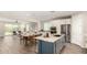 Open-concept kitchen featuring a large island with bar seating, open to living area at 19595 W San Miguel Ave, Litchfield Park, AZ 85340