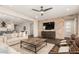 Open-concept living room featuring a brick accent wall and dark wood flooring at 19595 W San Miguel Ave, Litchfield Park, AZ 85340