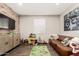Cozy living room featuring modern brick wall and a leather sofa, perfect for relaxation and entertainment at 19595 W San Miguel Ave, Litchfield Park, AZ 85340