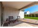 Charming covered patio with chairs, offering a cozy outdoor space for relaxation and enjoying the scenery at 19595 W San Miguel Ave, Litchfield Park, AZ 85340