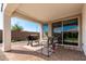 Inviting covered patio features a grill and comfortable seating, ideal for outdoor entertaining and relaxation at 19595 W San Miguel Ave, Litchfield Park, AZ 85340