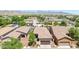 An elevated view displays the house with a well maintained yard and scenic mountain backdrop at 20699 W Ridge Rd, Buckeye, AZ 85396