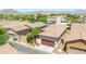 Aerial view showcases the home's driveway and landscaping, complemented by mountain views at 20699 W Ridge Rd, Buckeye, AZ 85396