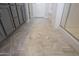 Bright, spacious bathroom with double sinks, sleek gray cabinetry, modern tile flooring, and a glass-enclosed shower at 20699 W Ridge Rd, Buckeye, AZ 85396