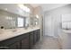 Spacious bathroom with double sinks, ample counter space, unique tile flooring, and a separate shower area at 20699 W Ridge Rd, Buckeye, AZ 85396