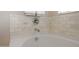 Close-up of an elegant bathroom tub with marble tiling, sleek chrome fixtures, and a refreshing design at 20699 W Ridge Rd, Buckeye, AZ 85396