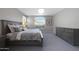 Spacious bedroom featuring a comfortable bed with plush pillows, a decorative light fixture, and ample natural light at 20699 W Ridge Rd, Buckeye, AZ 85396