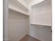 This is a spacious walk-in closet with built-in shelving and hanging rods for ample storage at 20699 W Ridge Rd, Buckeye, AZ 85396