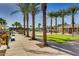 Inviting community pool area surrounded by lush greenery, palm trees, and comfortable seating for relaxation and enjoyment at 20699 W Ridge Rd, Buckeye, AZ 85396