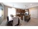 Open dining area features a chandelier, island seating, and stainless steel appliances at 20699 W Ridge Rd, Buckeye, AZ 85396