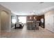 Bright dining area showcasing modern lighting, open to the kitchen, and tile flooring at 20699 W Ridge Rd, Buckeye, AZ 85396