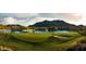 Golf Course green featuring mountain backdrop, lake and sand trap at 20699 W Ridge Rd, Buckeye, AZ 85396