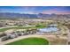 Expansive golf course showcasing lush greens, water features, and desert landscape surrounded by picturesque mountains at 20699 W Ridge Rd, Buckeye, AZ 85396
