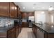 Open kitchen layout features granite countertops, stainless appliances and an island with bar stools at 20699 W Ridge Rd, Buckeye, AZ 85396