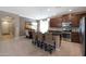 Modern kitchen with stainless steel appliances, breakfast bar, and a view of the dining area at 20699 W Ridge Rd, Buckeye, AZ 85396
