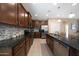 Granite countertops and stainless steel appliances highlight this open kitchen with island seating at 20699 W Ridge Rd, Buckeye, AZ 85396
