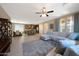 Open-concept living area featuring a large sectional sofa, adjacent to the kitchen and dining spaces at 20699 W Ridge Rd, Buckeye, AZ 85396