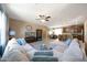 Spacious living room with a plush sectional sofa and seamless flow to the dining area at 20699 W Ridge Rd, Buckeye, AZ 85396