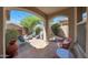 This covered patio features a seating area with a cozy outdoor ambiance and a beautiful archway design at 20699 W Ridge Rd, Buckeye, AZ 85396