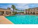 Resort-style pool with spacious deck, palm trees, and splash pad at 20699 W Ridge Rd, Buckeye, AZ 85396