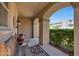 Covered porch features a wooden bench, patterned rug, and stucco columns at 20699 W Ridge Rd, Buckeye, AZ 85396