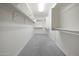 Well-organized walk-in closet with extensive shelving, rod space, and carpeted flooring for optimal storage at 20699 W Ridge Rd, Buckeye, AZ 85396