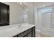 Bathroom featuring a spacious white countertop, vanity with cabinet and shower with tub at 22218 N 28Th St, Phoenix, AZ 85050