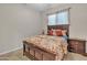 Comfortable bedroom featuring a wood-framed bed with decorative pillows and side tables at 22218 N 28Th St, Phoenix, AZ 85050
