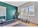 Bright exercise room with a green accent wall and workout equipment at 22218 N 28Th St, Phoenix, AZ 85050