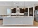 Modern kitchen featuring a large island, stainless steel appliances, and stylish pendant lighting at 22218 N 28Th St, Phoenix, AZ 85050