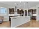 Modern kitchen featuring a large island, stainless steel appliances, and dark wood cabinets at 22218 N 28Th St, Phoenix, AZ 85050