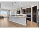 Spacious kitchen features a central island, stainless steel appliances and dark wood cabinets at 22218 N 28Th St, Phoenix, AZ 85050