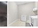 Laundry room features tiled floors, a freezer, and washer and dryer, and wall-mounted shelves at 22218 N 28Th St, Phoenix, AZ 85050