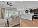 Open concept living room and kitchen with stainless appliances and wood floors at 22218 N 28Th St, Phoenix, AZ 85050