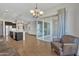 Open-concept living area flowing into a modern kitchen, with sliding doors to outdoor space at 22218 N 28Th St, Phoenix, AZ 85050