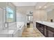 Beautiful main bathroom with a soaking tub, double vanity, and marble tile floors at 22218 N 28Th St, Phoenix, AZ 85050