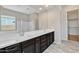 Spacious main bathroom with double vanity, tiled floors, and walk-in closet access at 22218 N 28Th St, Phoenix, AZ 85050
