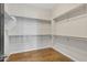 Well-organized walk-in closet with shelving and hardwood flooring at 22218 N 28Th St, Phoenix, AZ 85050