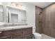 Bathroom featuring a decorative mirror, updated vanity, and a tiled walk-in shower at 2250 E Deer Valley Rd # 96, Phoenix, AZ 85024