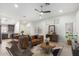 Staged living room showcasing the kitchen, a ceiling fan, and natural light at 2250 E Deer Valley Rd # 96, Phoenix, AZ 85024